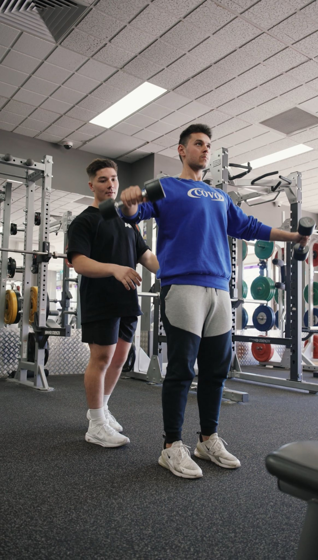 A Fortis coach guiding a client's form